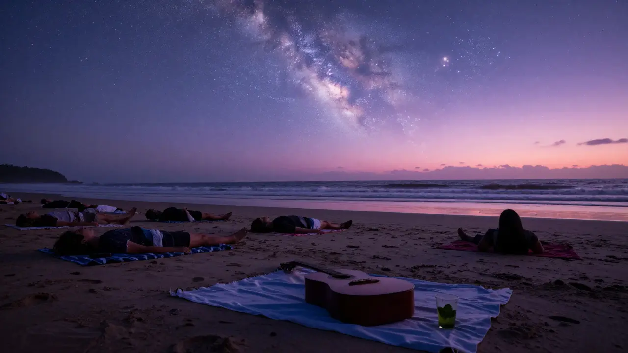 Silhouettes lying on blankets at dawn on a beach, watching the sunrise in peaceful silence.